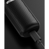 Black body groomer on a textured surface and cable on a dark background