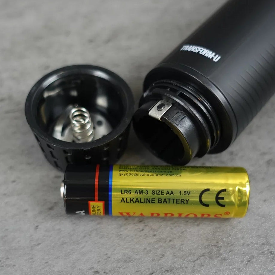 nose and ear trimmer AA battery on a gray surface
