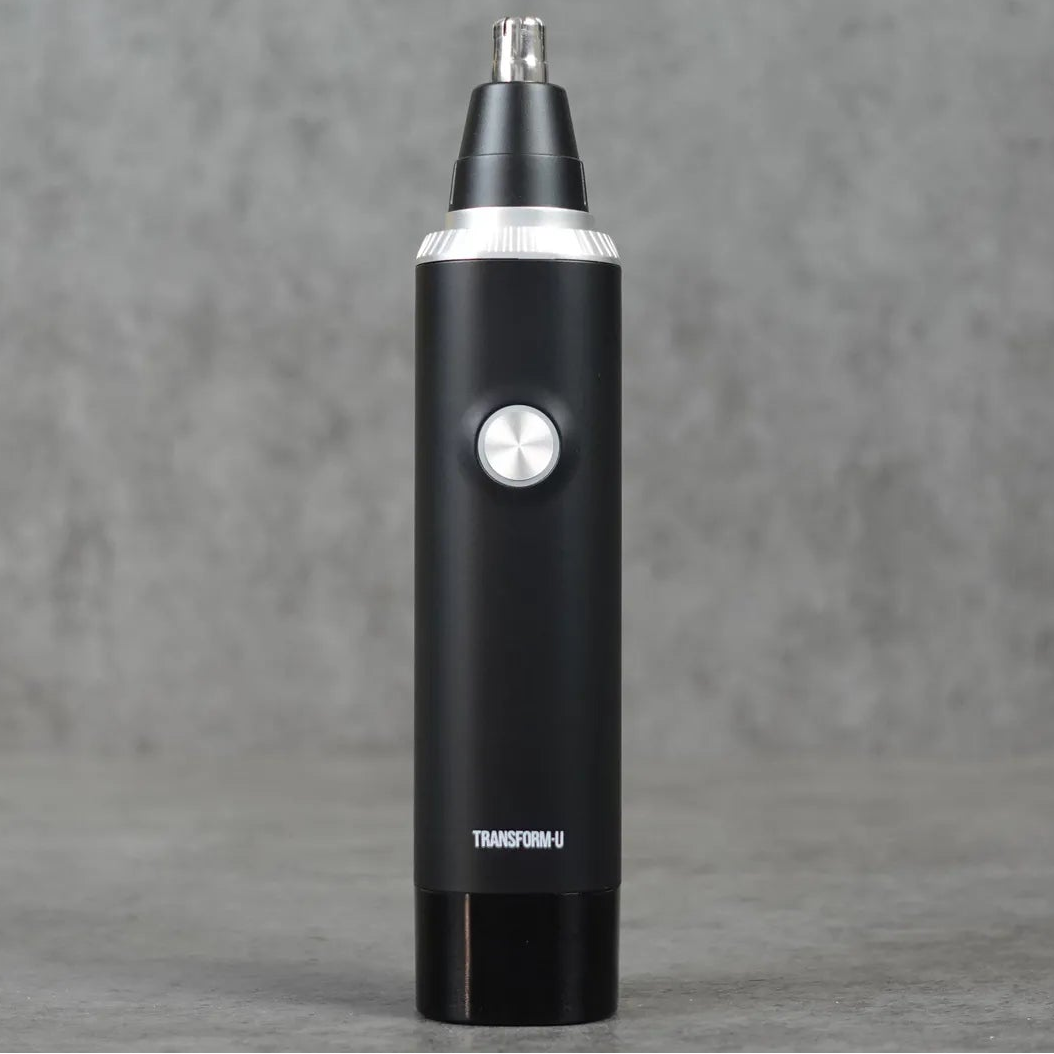 Black electric nose hair trimmer on a gray background