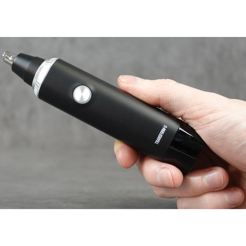 Hand holding a nose and ear hair trimmer against a grey background