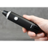 Hand holding a nose and ear hair trimmer against a grey background