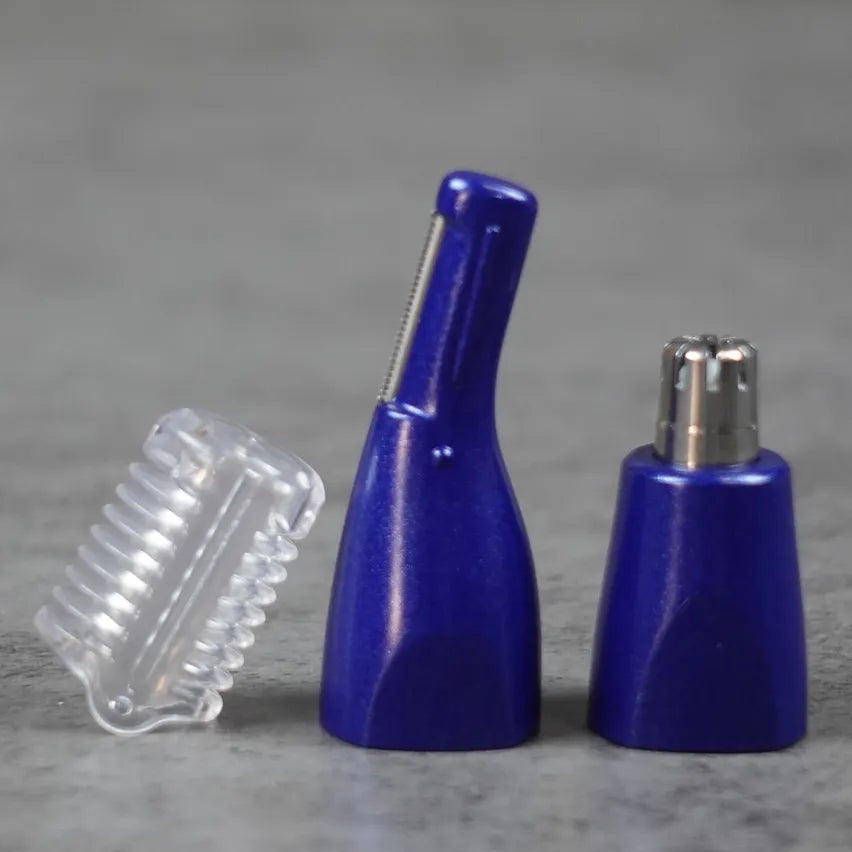 Two blue nose and ear hair trimmer attachments and a clear plastic cover on a gray surface