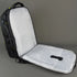 Black backpack with a white interior on a gray background
