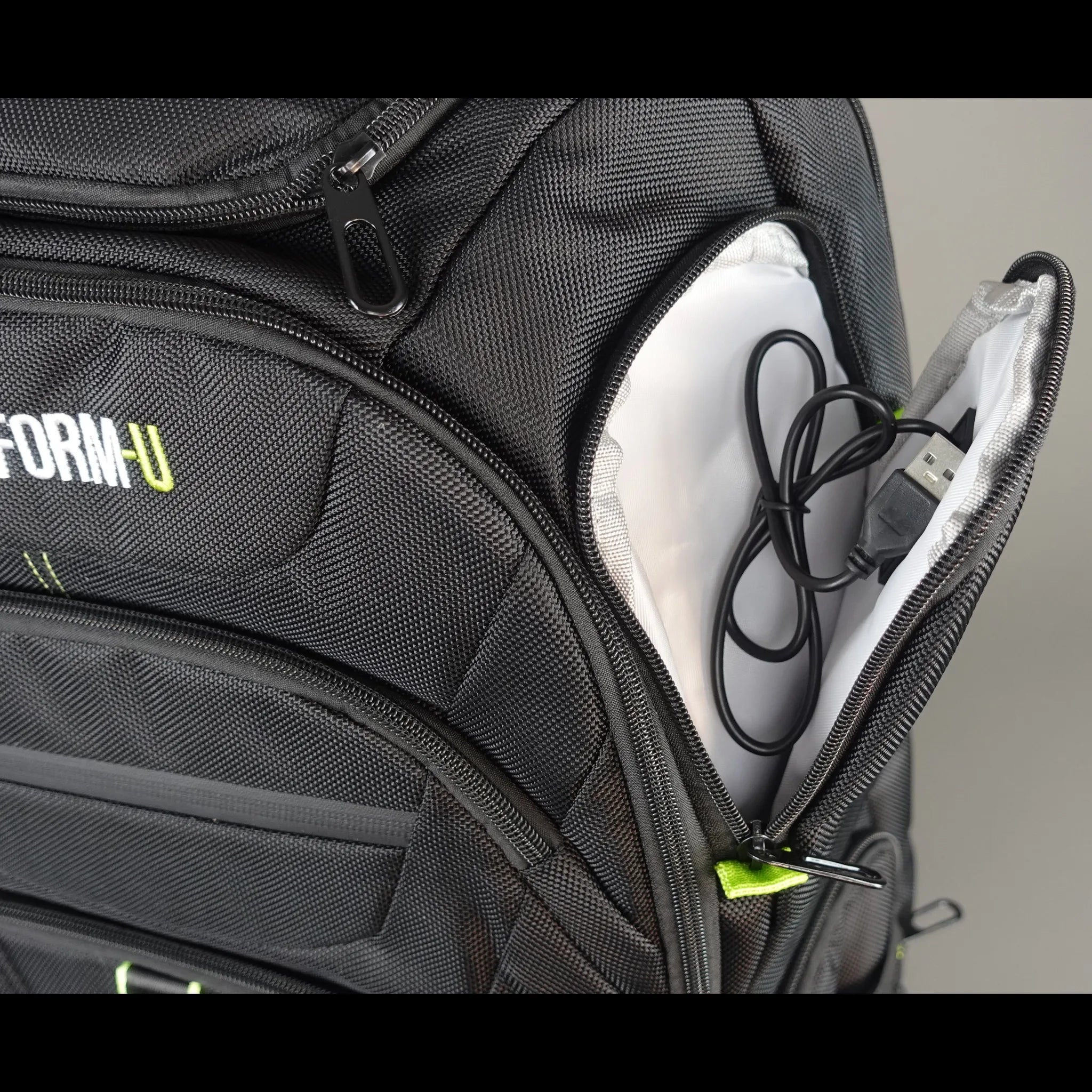 Black backpack with 'TRANSFORM U' branding on a gray background