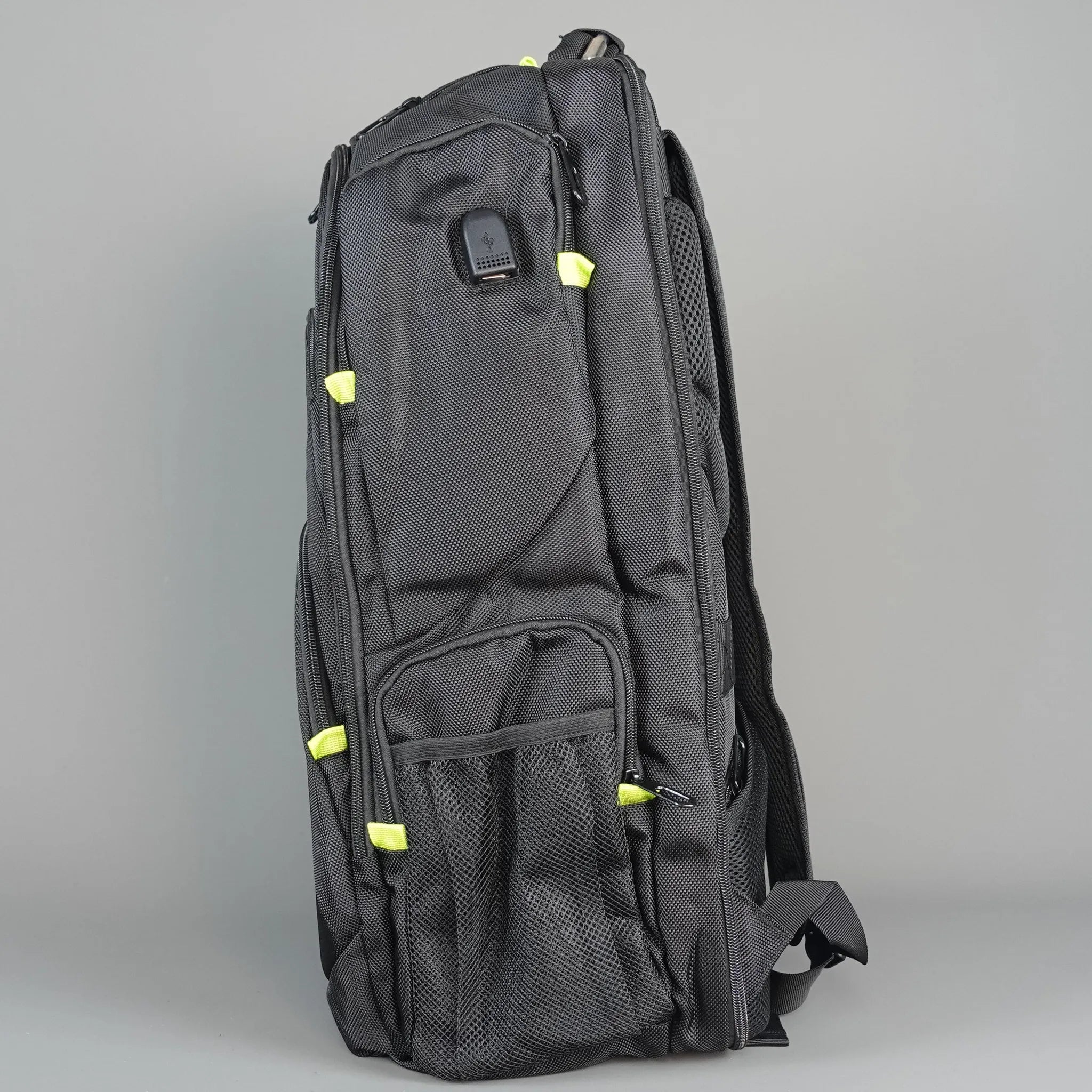 Black backpack with green accents on a gray background