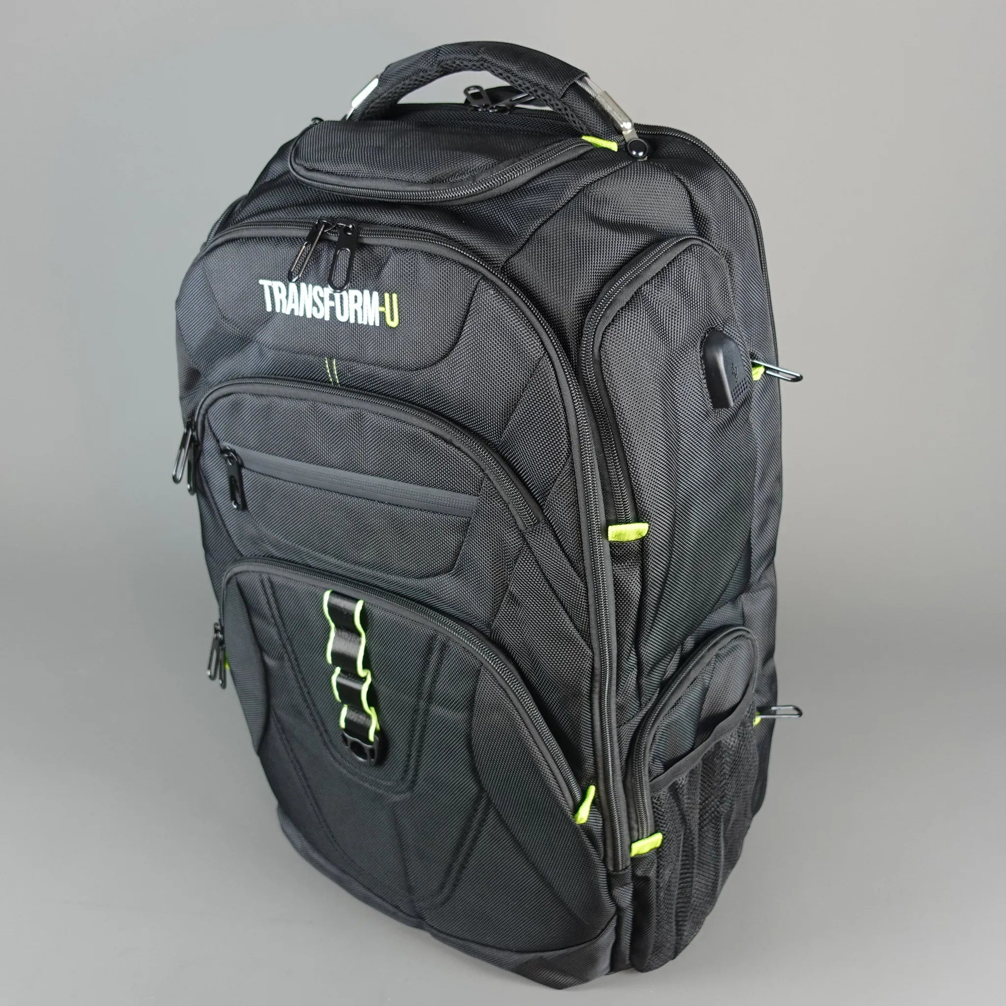Black backpack with green accents on a gray background