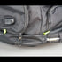 Gray backpack with multiple zippers on a light gray background