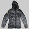A dark gray hooded puffer jacket with horizontal quilting, a front zipper, and a bright neon yellow geometric logo patch on the left sleeve, shown against a solid black background.