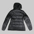 A black hooded puffer jacket shown from the back, featuring horizontal quilting and long sleeves, photographed against a solid black background.