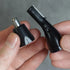 Two small blacknose and ear hair trimmer components held by hands against a gray background