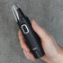 nose and ear trimmer held against a grey background