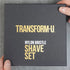 Black shave set box with gold text 'TRANSFORM-U' held by a hand on a gray background