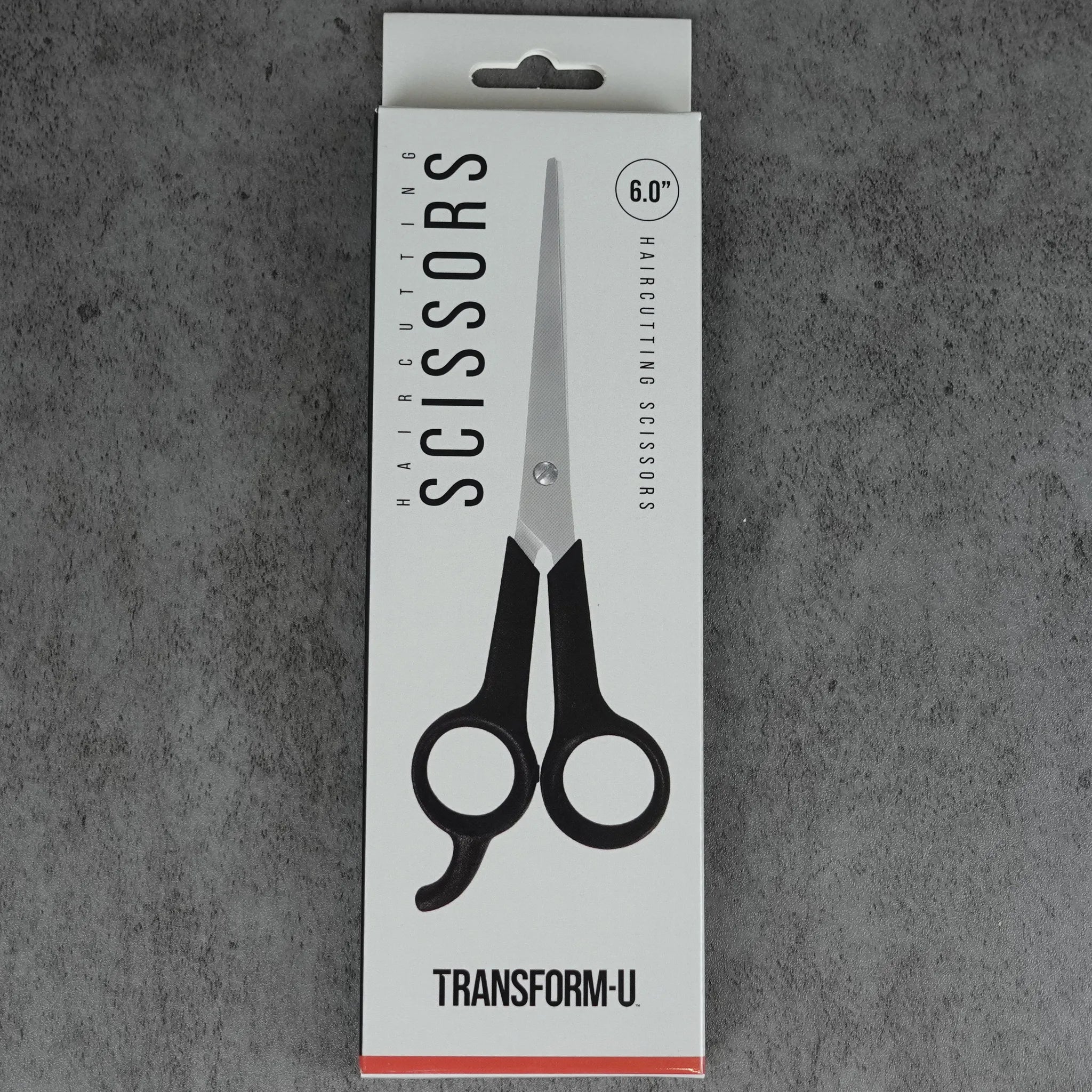 Packaging of Transform-U hair cutting scissors on a gray background