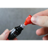 Person using a black blade oil bottle with a close-up of the nozzle.