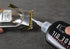 Hair clipper with a bottle of oil being applied on a dark surface