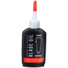 Hair clipper blade oil bottle with black label and red cap on transparent background