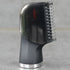 Black sensitive body groomer head attachment on a gray background