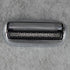 Metallic shaver head on a gray textured background