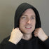 Person wearing a black hoodie against a plain background