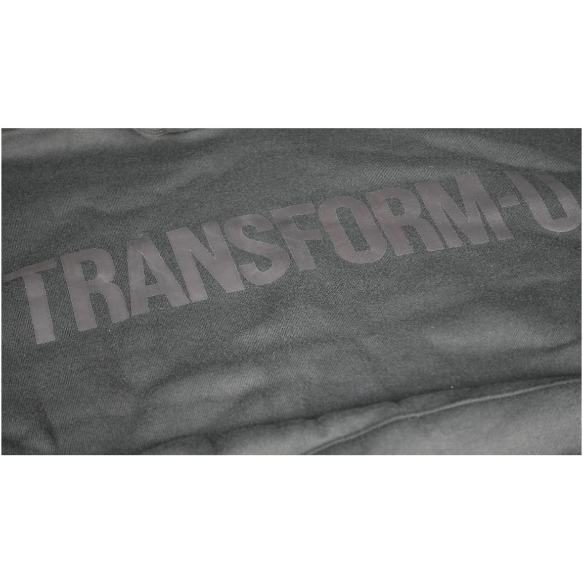 Gray hoodie with 'TRANSFORM-U' text on a dark background