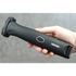 Hand holding a black body grooming tool with 'Transform-U' branding against a gray background