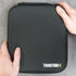 Black carrying case with 'TRANSFORM-U' branding held by hands on a gray background