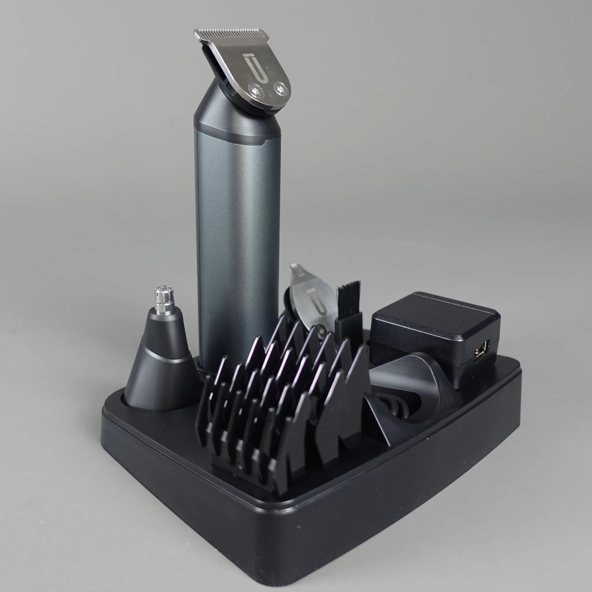 Hair trimmer set with attachments on a gray background