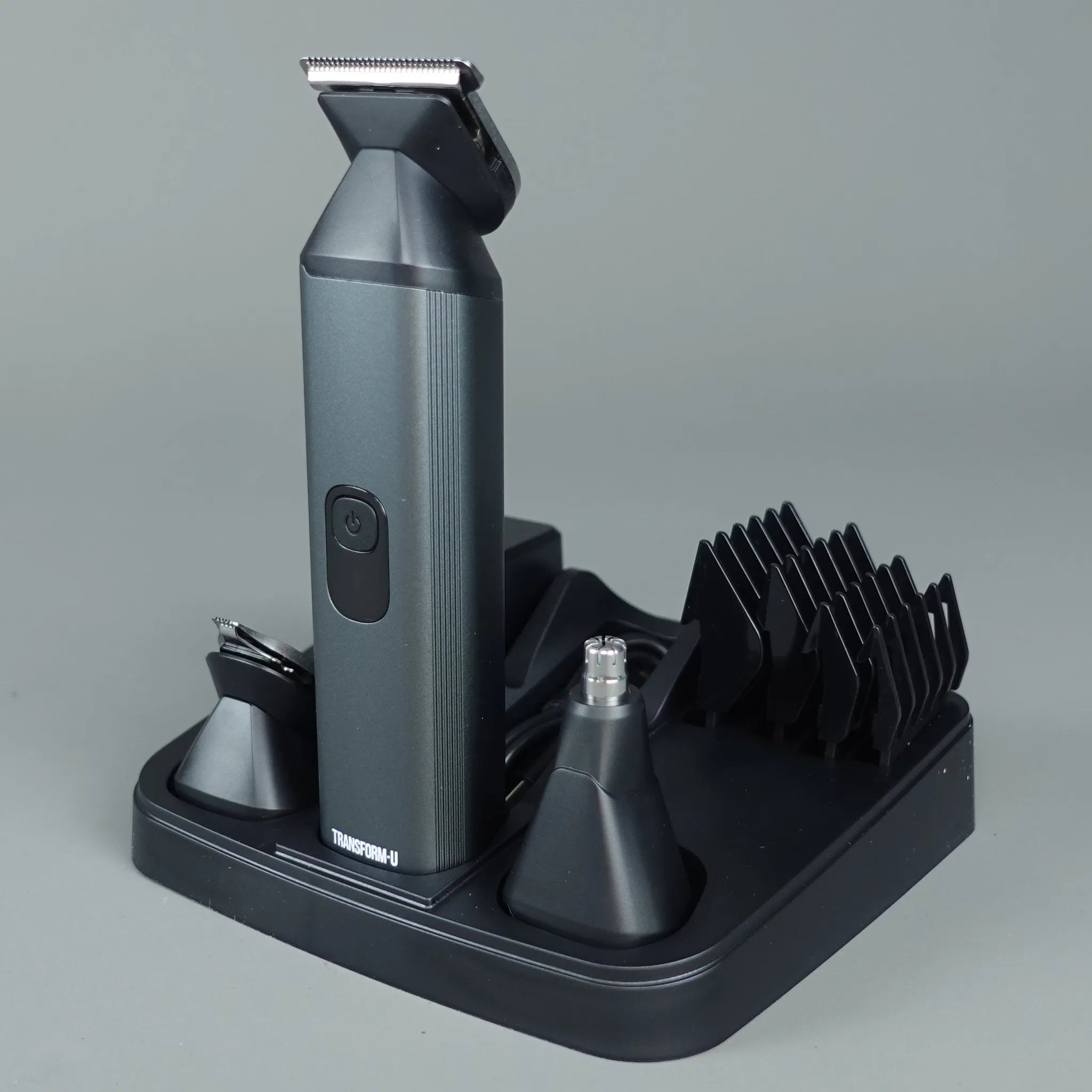 Gray grooming tool with attachments on a gray background