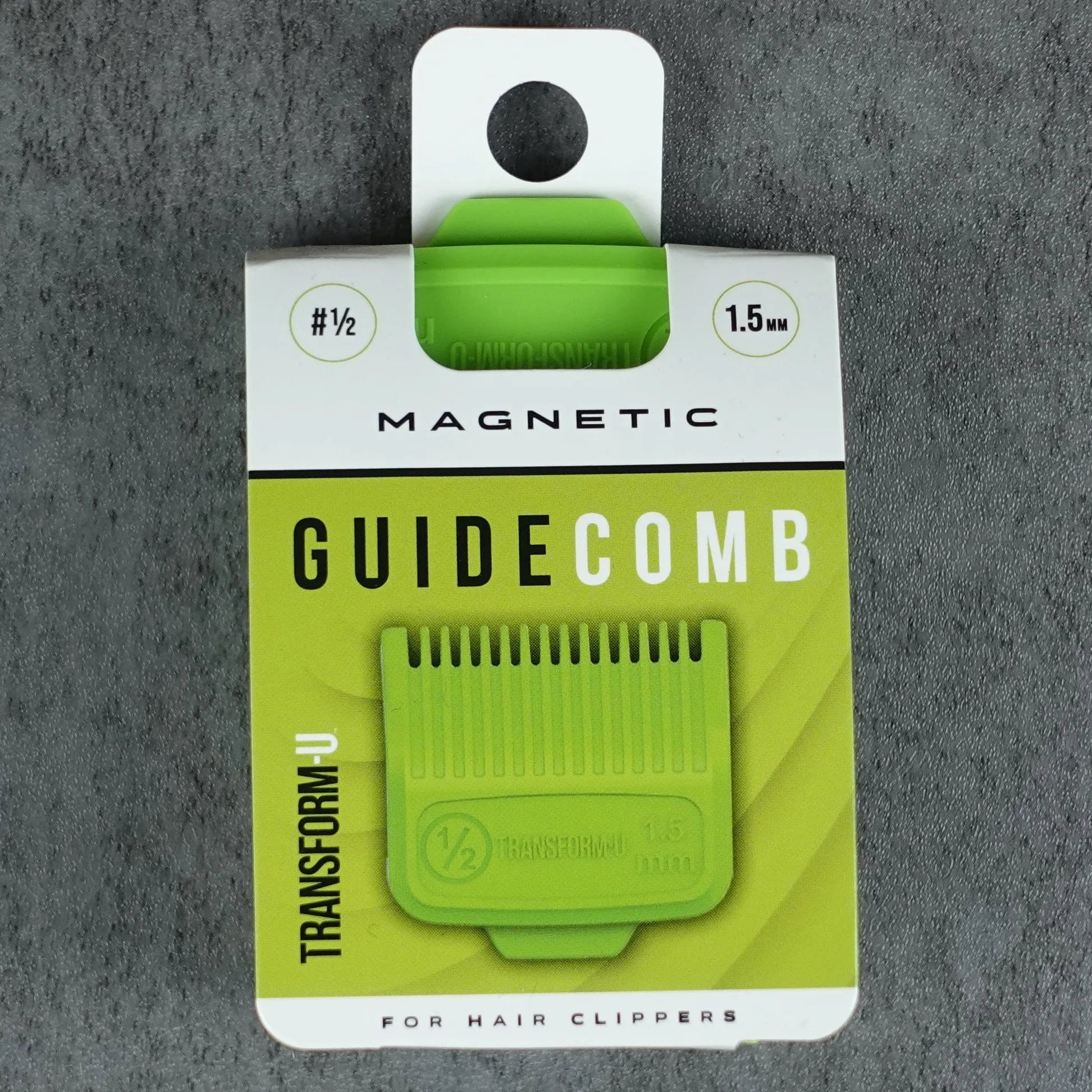 Green guide comb on a gray textured background