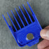 Blue hair clipper comb held by a hand on a gray background
