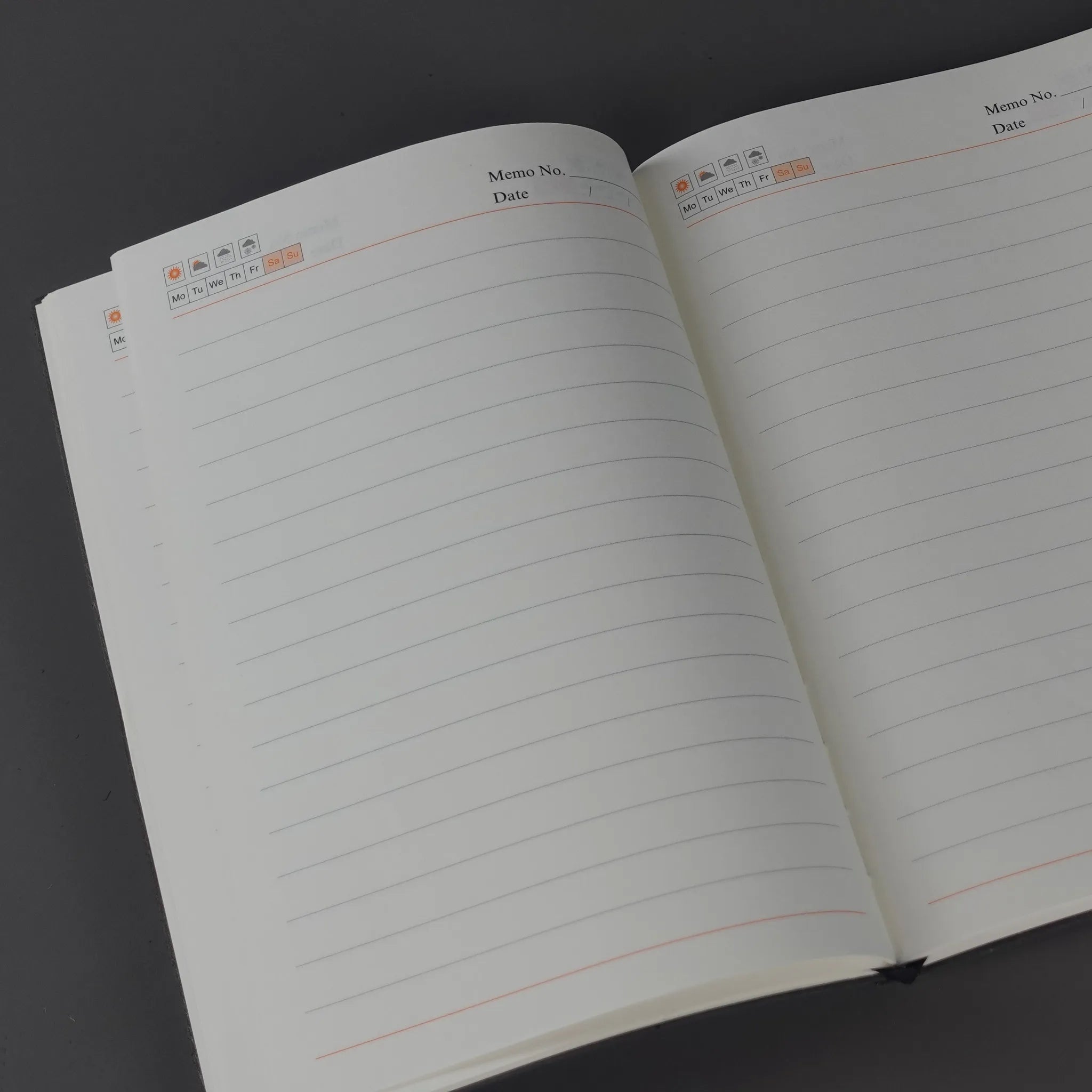 Open notebook with lined pages on a dark background