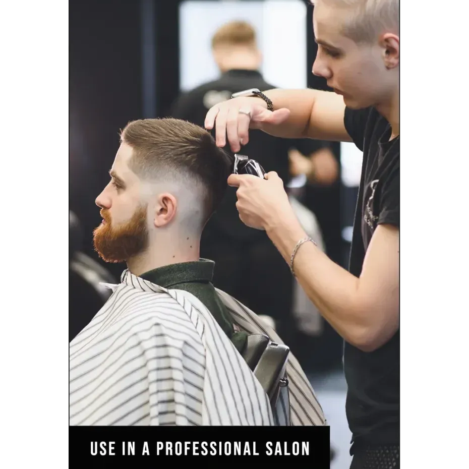 a man getting his hair clipped in a professional salon