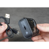 Person holding a USB-C cable and a travel shaver against a gray background