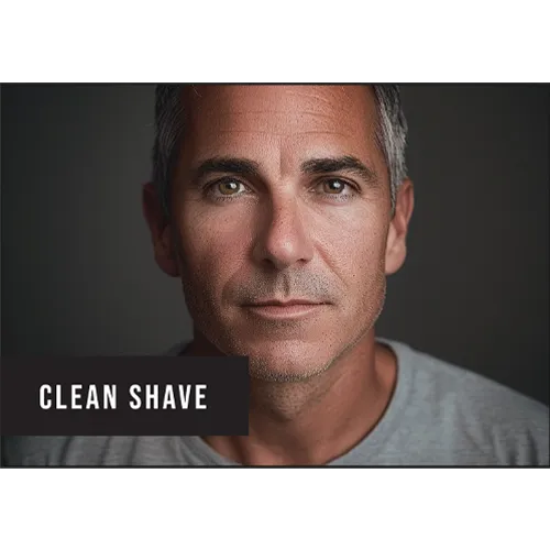 Man with a clean-shaven face and gray hair, wearing a gray shirt against a dark background.