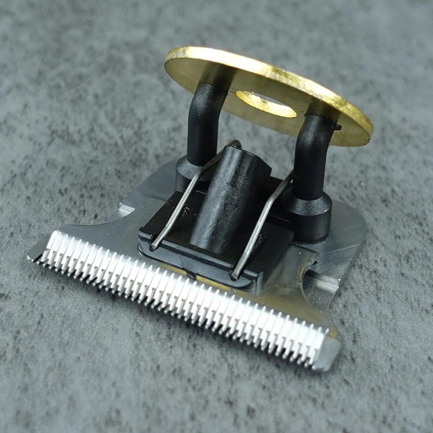 Hair trimmer head with magnetic base on a gray background