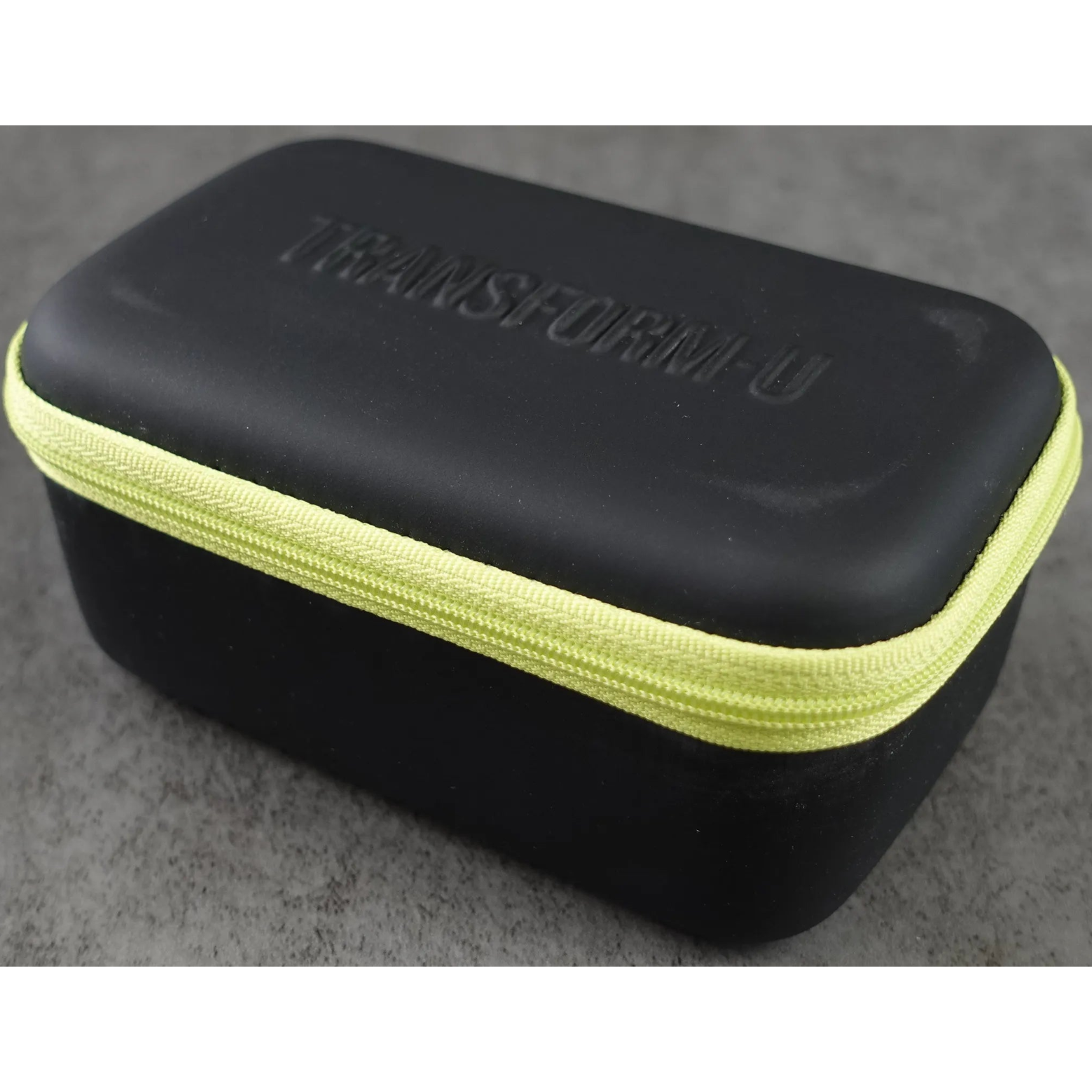 Black carrying case with green zipper on a gray background