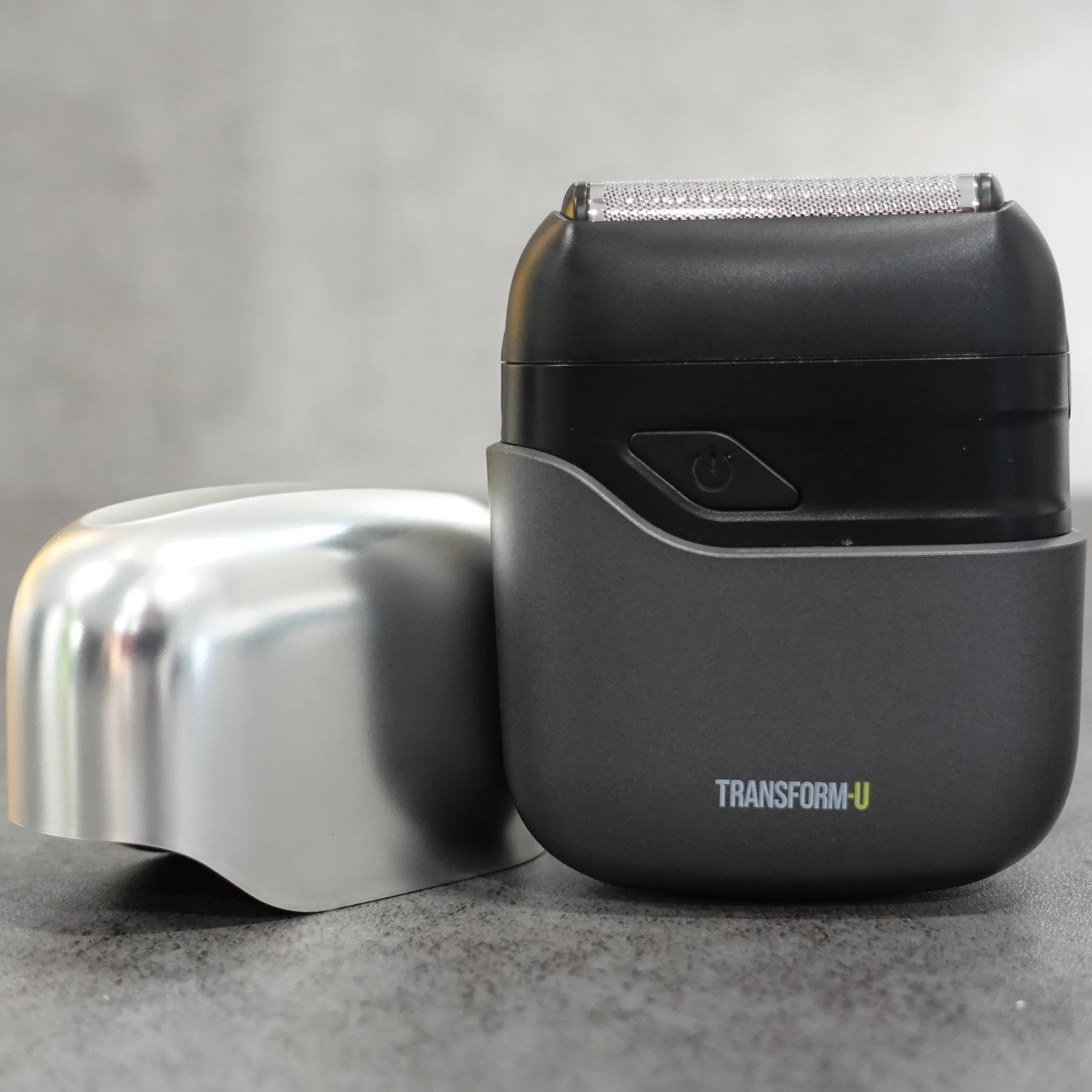 Shaver with a protective cover on a gray surface