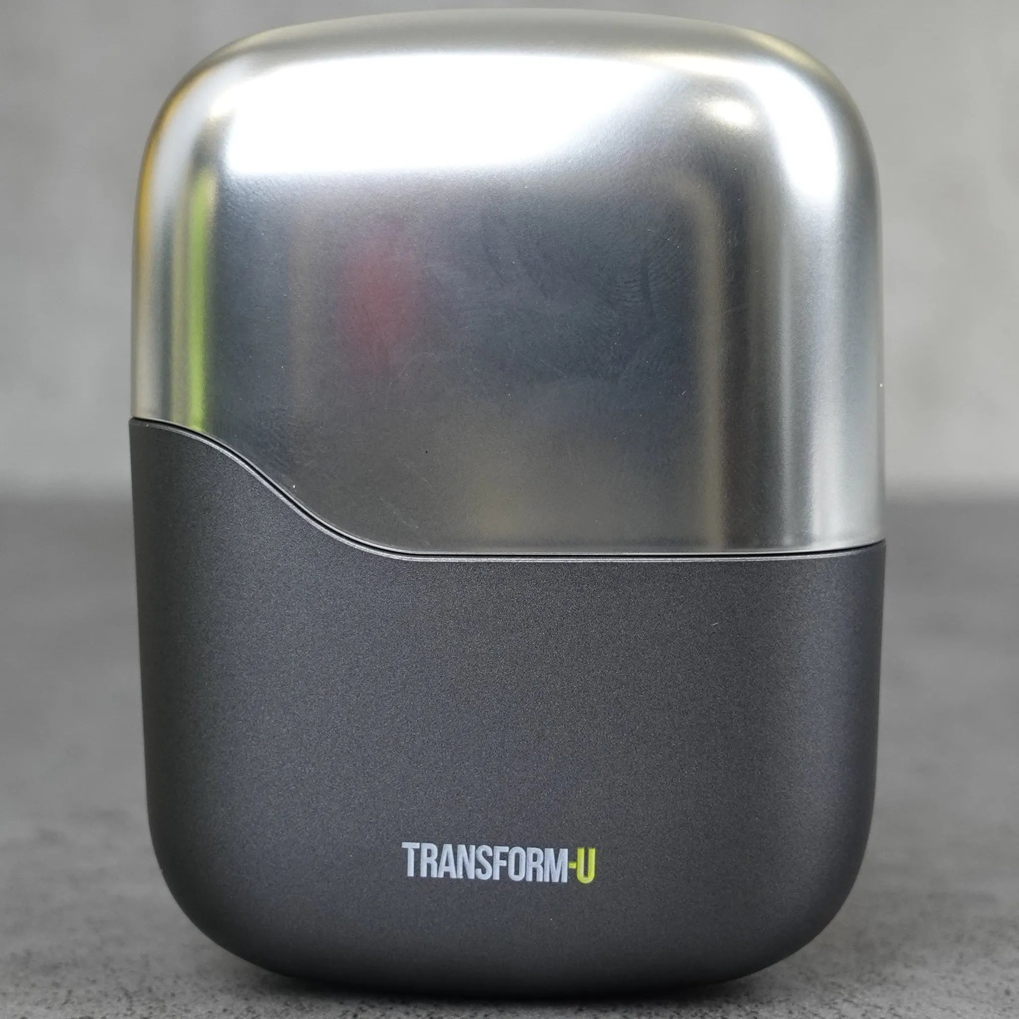 Electric shaver with 'TRANSFORM-U' branding on a gray background