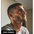 Man with a styled beard and short haircut looking to the side, with 'Beard Trimming' text at the bottom.