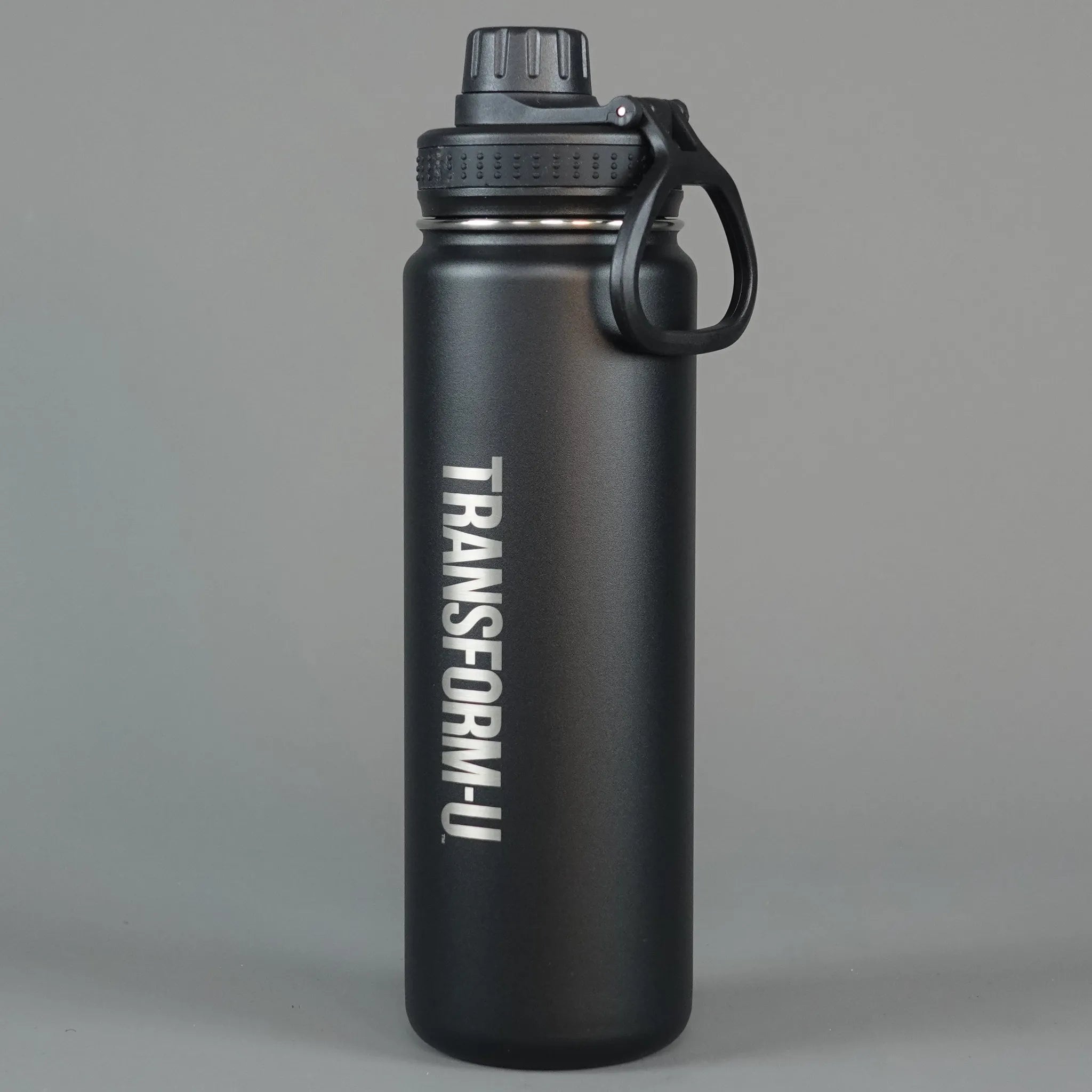 Black water bottle with 'TRANSFORM-U' branding on a gray background