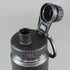 Close-up of a black water bottle with a metallic cap on a light gray background